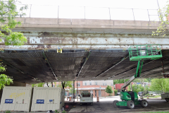 May 2019 - Workers install shielding to collect debris to the underside of the viaduct over Philadelphia's Nicetown section.